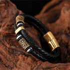 Bracelet en cuir tressé noir avec pendentif doré