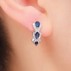 Boucles d'oreilles avec blason royal et pierres précieuses