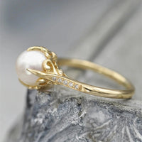 Bague vintage avec perle dorée au centre