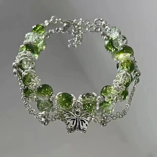Bracelet vintage avec papillon argenté et perles vertes