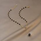 Collier vintage avec perles noires et pendentif en forme de goutte
